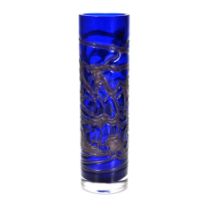 A cobalt blue, tall cylinder art glass vase with iridescent flowing abstract trail work and clear...