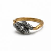 A nine stone diamond cluster ring, to a 22 carat gold shank, the three rows of three diamonds est...