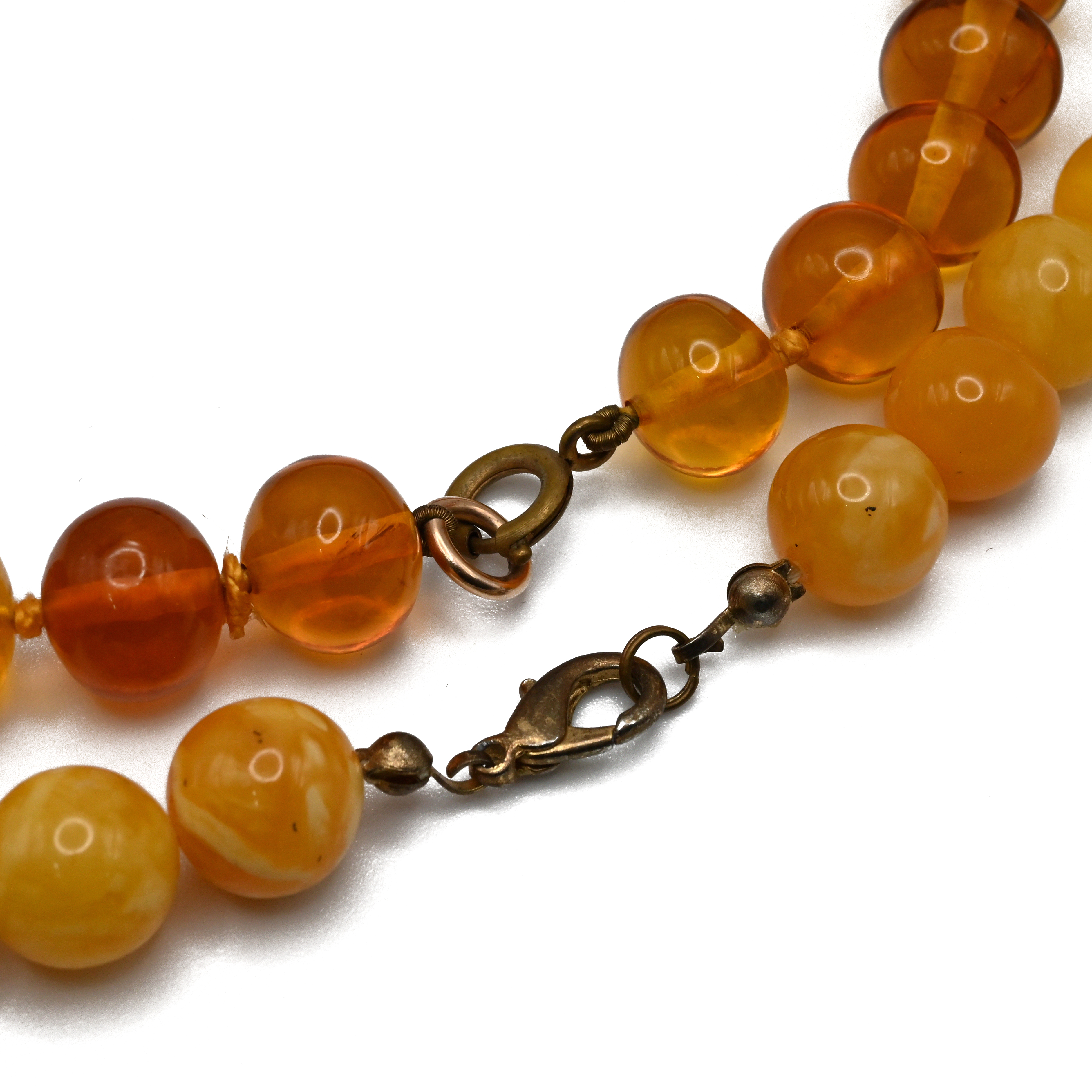 A row of clear amber beads and two other amber style bead necklaces. - Image 2 of 2