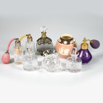 Three glass atomisers, two clear and one purple, a frosted glass metal mounted perfume bottle, a ...