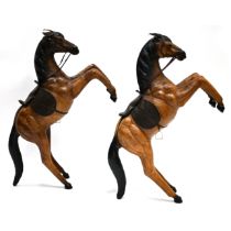 Two decorative leather covered rearing horses in the manner of Liberty. Dimensions each: 85cm hig...
