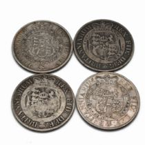 A selection of four sterling silver King George III Half Crown coins minted in the years 1816-181...