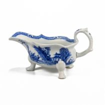 Mid 18th Century three footed blue and white Bow sauce boat. The outside of the bowl decorated wi...