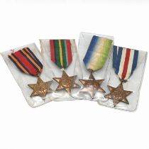 A group of four World War Two star medals to include: The Atlantic Star, The Pacific Star, The Bu...