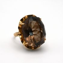 A smoky quartz dress ring, stamped ‘14K’, finger size M 1/2, 8 grams gross.