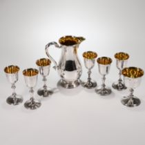 A silver wine jug with a matched set of six silver wine goblets, and a larger goblet, Royal Irish...