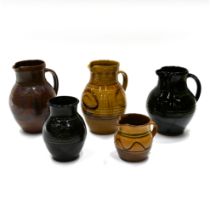 A quantity of Cricklade pottery, to include 4 jugs and 1 vase. The vase with black ground and sgr...