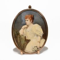 An early 20th century portrait miniature of a female, clutching a bouquet white flowers. In 9ct g...