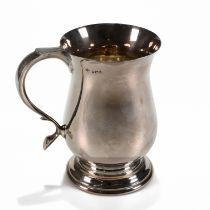 A modern silver mug, maker DH, Sheffield 1969, of plain baluster form, scroll handle, 13.5cm high...