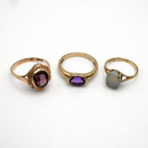 A 9 carat gold single stone opal ring; with two 9 carat gold amethyst dress rings, 7 grams gross.