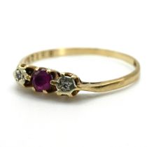 A 9 carat gold ruby and illusion set diamond three stone ring, 1.4 grams gross.