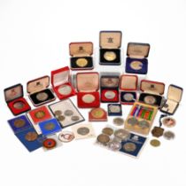 An assortment of GB and world coins, medallions and tokens to include: WWII War and Defence Medal...