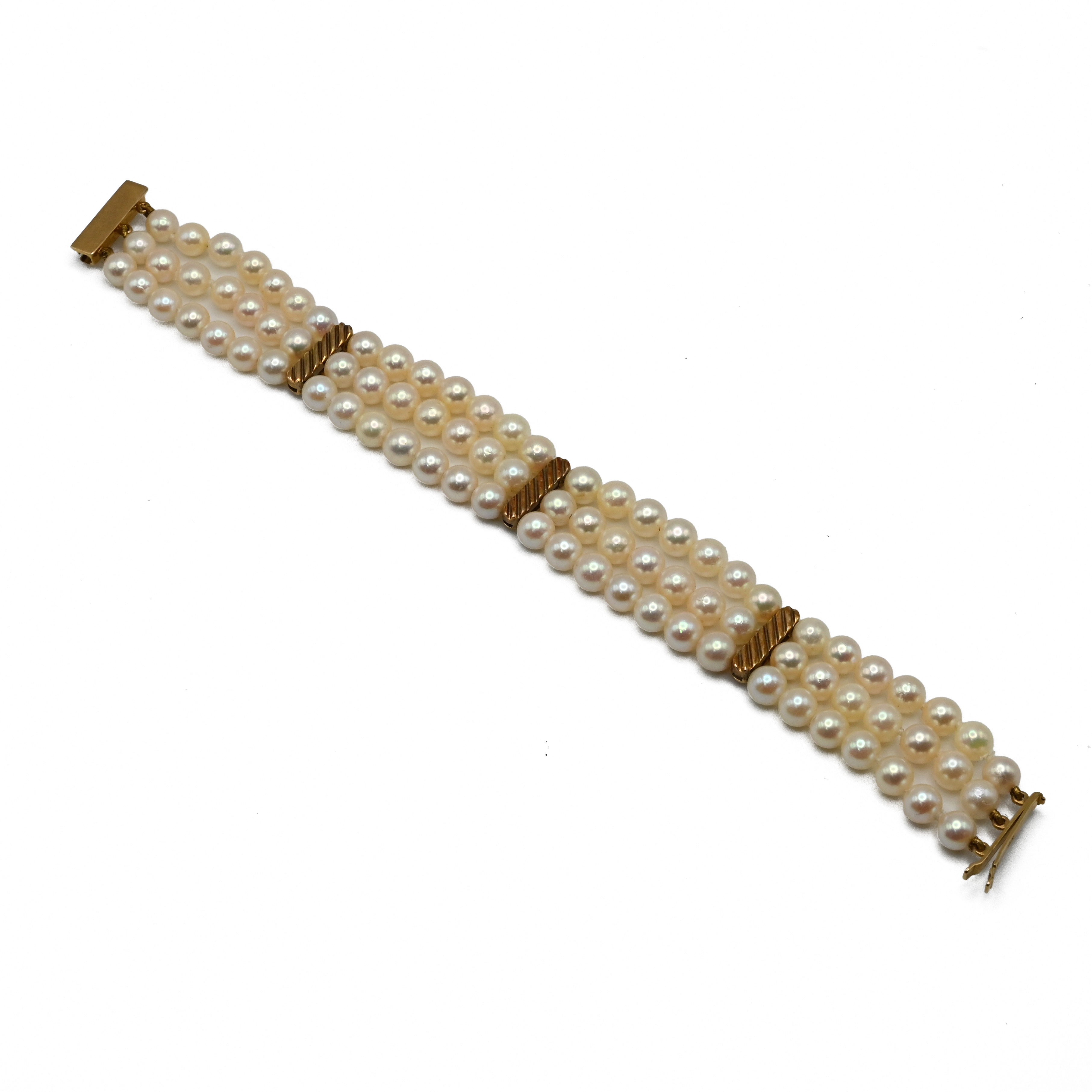 A uniform three row cultured pearl bracelet, with textured yellow metal dividers and catch, the
l... - Image 2 of 2