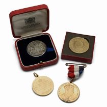 A group of four medallions issued to commemorate the coronations of various British monarchs thro...