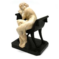 An Art-Deco Alabaster figure of a semi-naked young woman seated on a bronze four legged chair wit...