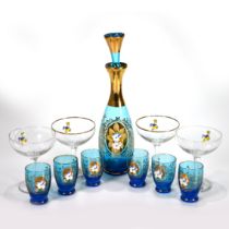 A Moser blue glass decanter with stopper (29cm) and six cordial/liqueur glasses (6.8cm), with gil...