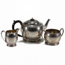 A three piece silver tea service, Elkington & Co, Birmingham 1935, of circular form with dot and ...