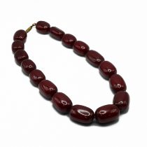 A row of large oval dark opaque cherry amber style beads, 132 grams.