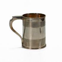 A Georgian silver mug, makers mark worn, London 1810, the can shaped body with reeded bands, 12.5...