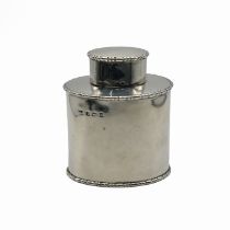 A silver tea caddy, makers mark worn, Birmingham 1911, of plain oval outline with egg and dart bo...