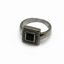 A sapphire and diamond cluster ring, the white mount stamped ’18K750’, the square cut sapphire en...