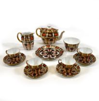 A part tea set by Royal Crown Derby comprising teapot, milk jug, sugar bowl, sandwich plate, four...