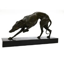 A well patinated bronze study of a prowling Greyhound, finely figured, on a rectangular marble ba...