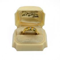 A late Victorian three stone diamond ring, stamped ‘18ct’, the graduated old brilliant cuts total...