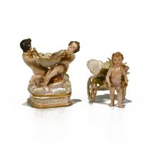 Two 19th Century bonbon dishes. The first in the form of two cherubs holding a basket all decorat...