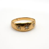 An 18 carat gold ring, star set with three small diamonds, finger size L 1/2, 2.7 grams gross.