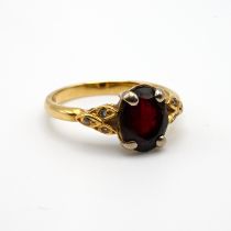 An 18 carat gold garnet and diamond dress ring, finger size N, 3.9 grams gross.