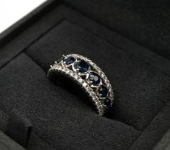 An 18ct white gold, diamond and sapphire Vera Wang love ring, set with seven sapphires and 0.29 c...