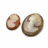 A shell cameo brooch in a mount stamped ‘9kt’; with another smaller 9 carat gold mounted cameo br...