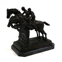 A dark brown patinated bronze sculpture of two racing horses and their jockeys taking a fence in ...