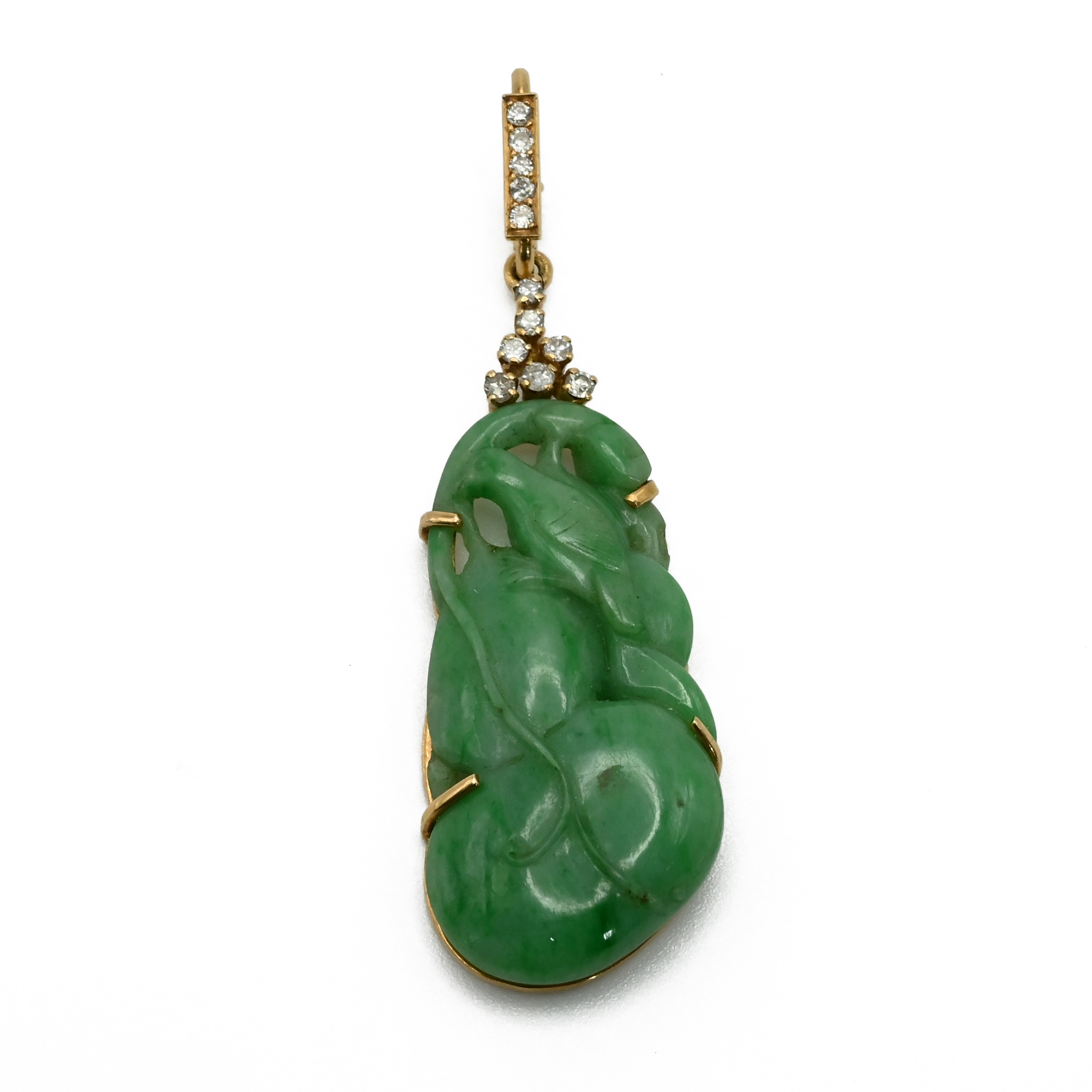A jade and diamond pendant, the jade carved as a bird and fruit with seven brilliant cuts above,
...