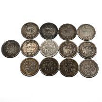 A group of 13 sterling silver one shilling coins minted during the reigns of King George III and ...
