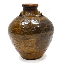 A late 19th century Chinese martaban stoneware jar, set with four rope twist handles to the shoul...