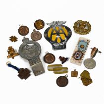 A collection of badges including: a South African AA badges; The Royal East African Automobile As...