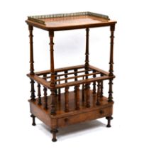 A mid 19th Century walnut Canterbury with gilt cast metal gallery to top. Turned supports and rai...