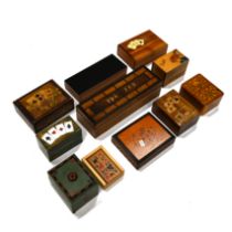 A collection of 20th Century treen boxes including two cribbage boards, one containing dominoes a...