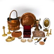 A Copper Helmet shaped coal scuttle containing a copper and brass companion set, two copper dustp...