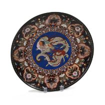 A late 19th Century Meiji Period Japanese Cloisonné dish depicting a dragon on a blue ground surr...