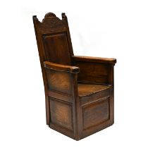 A Continental Lambing Chair constructed in Ash & Elm. Panel sides and back with shallow carved de...