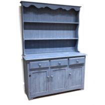 A late 20th Century blue painted pine dresser with two shelves above and three drawers below. Cup...