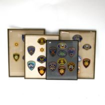 A group of 32 vintage US embroidered Police patches mounted within four matching frames. Largest ...