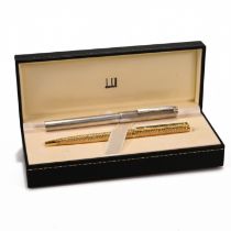 A gold plated Dunhill ballpoint ben and a Dunhill fountain pen with 14K gold nib in white medal c...