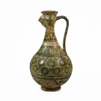 A Seljuk Kashan cockerel headed pottery ewer, decorated in geometric green glazes over a yellow g...