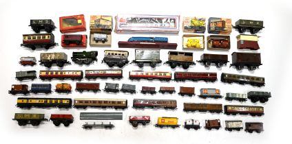 A mixed box of vintage tin-type and plastic toy trains, carriages and wagons. Makers include Horn...