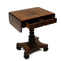 A William IV Rosewood drop leaf table. The rectangular top extending each side with flaps with ro...
