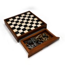 20th Century marble chessboard in a hardwood frame with two drawers under containing a gilt and s...